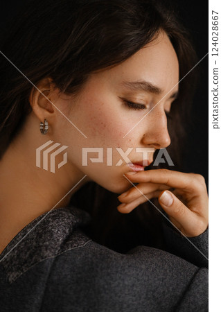 Close-up portrait of young and beautiful Caucasian woman with closed eyes. Close-up portrait of young and beautiful Caucasian woman with closed eyes. 124028667