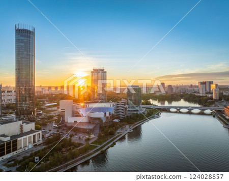 Yekaterinburg city and pond aerial panoramic view at summer or early autumn sunset. Night city in the early autumn or summer. Yekaterinburg city and pond aerial panoramic view at summer or early autumn sunset. Night city in the early autumn or summer. 124028857