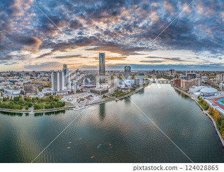 Yekaterinburg city and pond aerial panoramic view at summer or early autumn sunset. Night city in the early autumn or summer. Yekaterinburg city and pond aerial panoramic view at summer or early autumn sunset. Night city in the early autumn or summer. 124028865