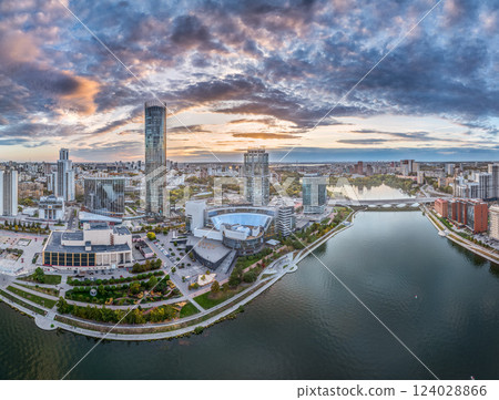 Yekaterinburg city and pond aerial panoramic view at summer or early autumn sunset. Night city in the early autumn or summer. Yekaterinburg city and pond aerial panoramic view at summer or early autumn sunset. Night city in the early autumn or summer. 124028866