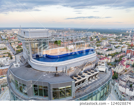 Aerial view of the Yekaterinburg city center with Vysotsky skyscraper. Beautiful landscape of a high-rise building with a rooftop pool and glass facade in Russia Aerial view of the Yekaterinburg city center with Vysotsky skyscraper. Beautiful landscape of a high-rise building with a rooftop pool and glass facade in Russia 124028874