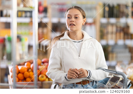 Woman with food basket in store 124029160