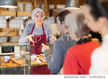 People place order at bakery, buy sweet pastries in cafeteria, girl worker serving people People place order at bakery, buy sweet pastries in cafeteria, girl worker serving people 124029222