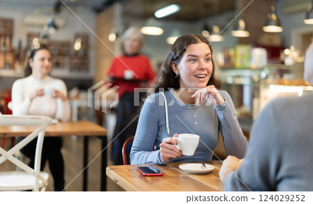 Couple, man and girl, meet in cafe for cup of coffee. Conversation of lovers Couple, man and girl, meet in cafe for cup of coffee. Conversation of lovers 124029252