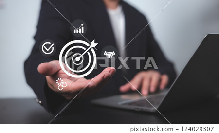 Targeting business concept, business objective, Successful business growth, Goals business, Hand man hold target business icon for strategic planning to business growth and target customer group. 124029307