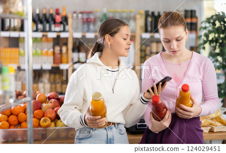 Young women scanning qr code for juices Young women scanning qr code for juices 124029451