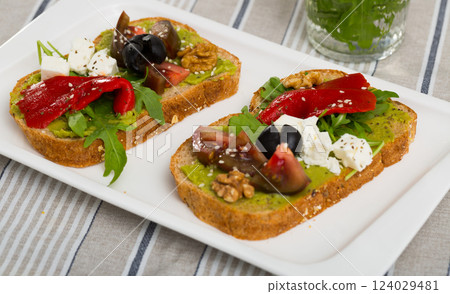 Bread with guacamole, soft cheese, vegetables, herbs Bread with guacamole, soft cheese, vegetables, herbs 124029481