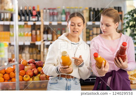 Two customers choose natural juices 124029558