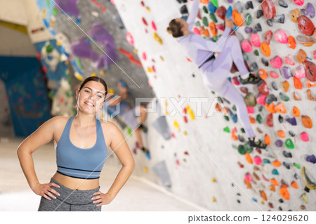 Young woman posing on climbing wall 124029620