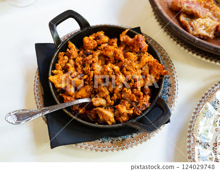 Image of fry pan with fried beef with chorizo on table 124029748