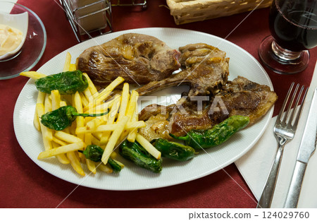 Baked tasty lamb chops served with fried potatoes and green pepper Baked tasty lamb chops served with fried potatoes and green pepper 124029760