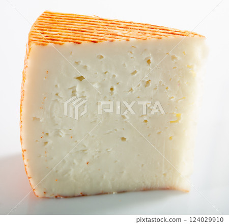 Piece of fresh semi-soft cheese Piece of fresh semi-soft cheese 124029910