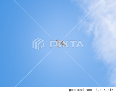 Small ultralight airplane with overhead wing and single propeller flying in sunset sky. 124030216