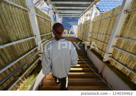 A woman waiting for a train at the station home 124030462