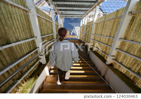 A woman waiting for a train at the station home A woman waiting for a train at the station home 124030463