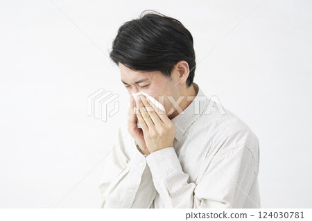 Man blowing his nose on white background 124030781