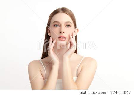 A beautiful young woman with clean, fresh skin against a white background. Skincare, facial treatment, cosmetology, beauty, and spa themes. An elegant portrait of an woman. 124031042