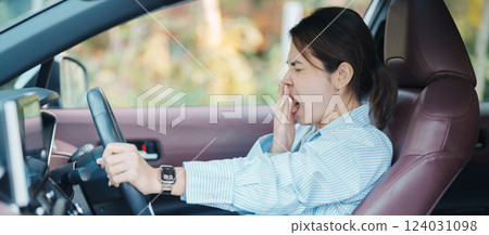 woman feeling sleepy and yawn during drive car long time. Asian girl tired and fatigue having headache after driving car in traffic jam. Sleep, stretching and safety concept woman feeling sleepy and yawn during drive car long time. Asian girl tired and fatigue having headache after driving car in traffic jam. Sleep, stretching and safety concept 124031098