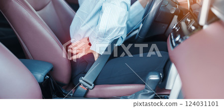 woman with her back sprain while driving car long time, back body ache due to Piriformis Syndrome, Low Back Pain and Spinal Compression. Ergonomic and medical concept woman with her back sprain while driving car long time, back body ache due to Piriformis Syndrome, Low Back Pain and Spinal Compression. Ergonomic and medical concept 124031101