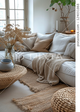 Modern living room with couch, coffee table and vase with flowers on it 124031868