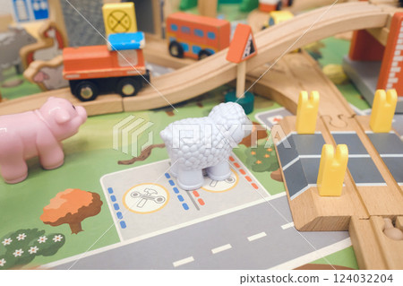 Colorful wooden playset with animal figurines in a vibrant children's play area during daytime Colorful wooden playset with animal figurines in a vibrant children's play area during daytime 124032204