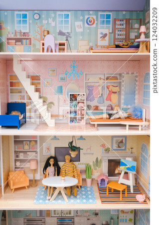 Colorful miniature dollhouse with detailed rooms and figurines, showcasing domestic life in a stylish interior setting Colorful miniature dollhouse with detailed rooms and figurines, showcasing domestic life in a stylish interior setting 124032209