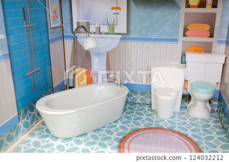 Miniature bathroom display features modern amenities and vibrant decor in a colorful design, showcasing a tub, sink, and toilet in a playful arrangement ideal for a dollhouse 124032212