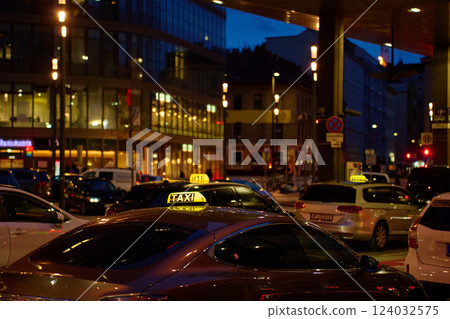 Row of taxis waiting on city street at night 124032575
