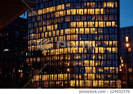 Illuminated office building at night in city Illuminated office building at night in city 124032576