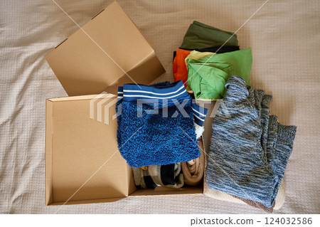 Boxes of Donated Clothes for Charity 124032586