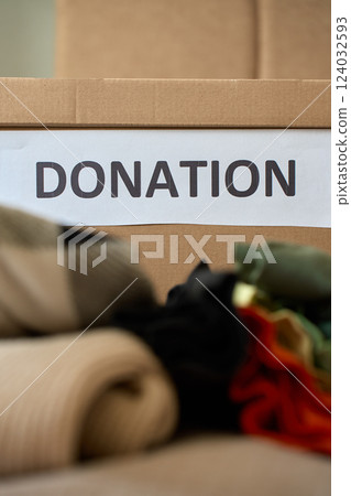 Clothes prepared for donation in cardboard box Clothes prepared for donation in cardboard box 124032593