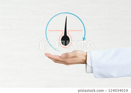 The hand of a person wearing a white coat holding up an icon representing the hair cycle 124034019