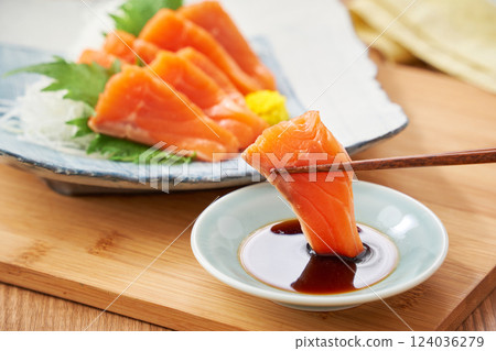 Fresh salmon sashimi with soy sauce 124036279