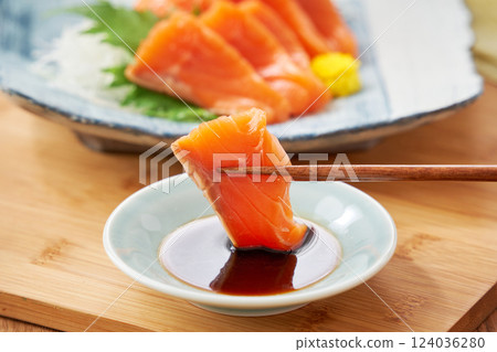 Fresh salmon sashimi with soy sauce 124036280