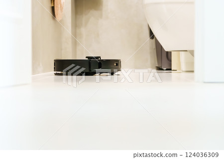 Robot vacuum cleaner performs automatic cleaning of the apartment at a certain time. Smart home. Robot vacuum cleaner performs automatic cleaning of the apartment at a certain time. Smart home. 124036309