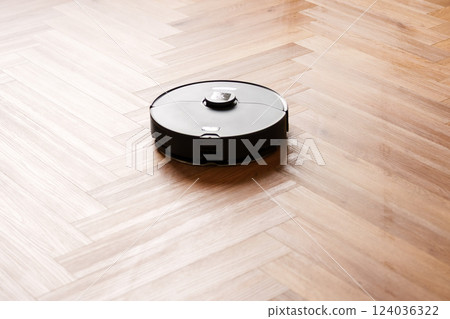 Robot vacuum cleaner performs automatic cleaning of the apartment at a certain time. Smart home. 124036322
