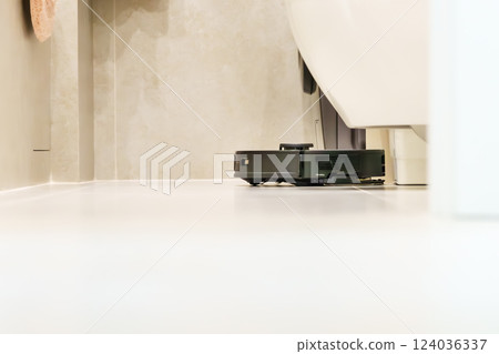 Robot vacuum cleaner performs automatic cleaning of the apartment at a certain time. Smart home. Robot vacuum cleaner performs automatic cleaning of the apartment at a certain time. Smart home. 124036337