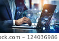 Young professional it specialist business man working on laptop pc sitting at desk in modern office space. 30s man using computer technology app for work online 124036986