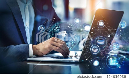 Young professional it specialist business man working on laptop pc sitting at desk in modern office space. 30s man using computer technology app for work online 124036986