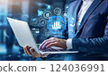 Young professional it specialist business man working on laptop pc sitting at desk in modern office space. 30s man using computer technology app for work online 124036991