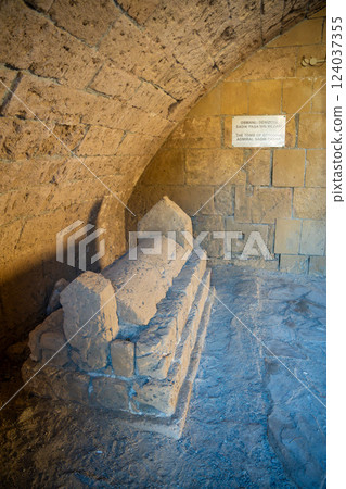 Ancient sarcophagus inside the historic fortress of Kyrenia or Girne in Northern Cyprus. Carved stone details and the dimly lit interior emphasize the mystery and historical depth of the site Ancient sarcophagus inside the historic fortress of Kyrenia or Girne in Northern Cyprus. Carved stone details and the dimly lit interior emphasize the mystery and historical depth of the site 124037355