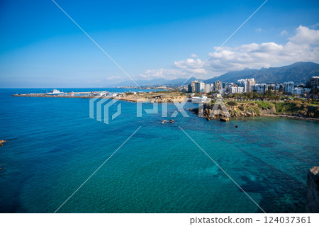 A panoramic view of the city from the fortress in Girne, Northern Cyprus. The historic walls overlook the urban landscape, blending medieval architecture with modern life 124037361