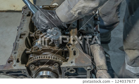 Auto mechanic working on car engine in mechanics garage.Repair service.Professional mechanic working on the engine of the car in the garage.Car repair service.Close-up hand of auto mechanic with tool Auto mechanic working on car engine in mechanics garage.Repair service.Professional mechanic working on the engine of the car in the garage.Car repair service.Close-up hand of auto mechanic with tool 124037677