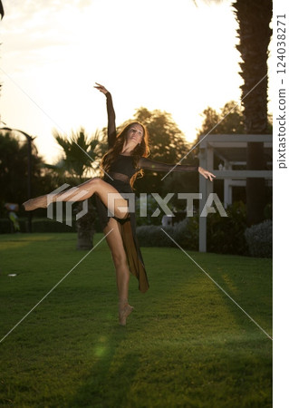 Elegant ballerina dancing gracefully at sunset  124038271