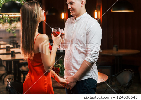 Two people standing together. Romantic couple have dinner in the restaurant Two people standing together. Romantic couple have dinner in the restaurant 124038545
