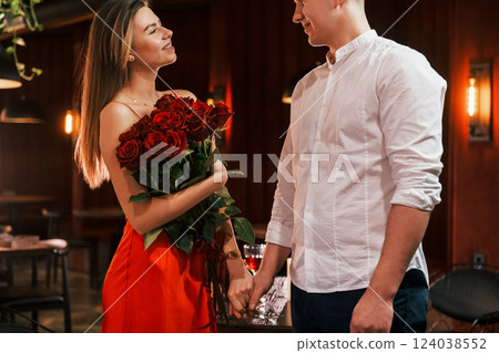 Beautiful roses. Romantic couple have dinner in the restaurant 124038552