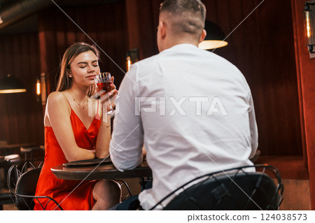 Talking with each other. Romantic couple have dinner in the restaurant 124038573