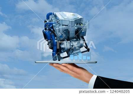 Engineer holds digital tablet with projection of hydrogen fuel cell engine 124040205