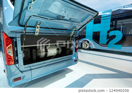 A hydrogen fuel cell buses. One bus with an open hood and a hydrogen cylinder inside 124040208