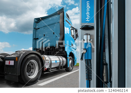 A hydrogen fuel cell semi truck with H2 gas cylinder onboard next to filling station. Eco-friendly commercial vehicle concept. 124040214